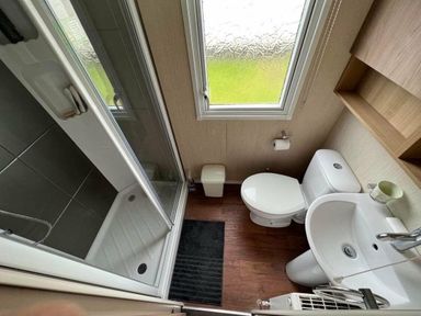 a bathroom with a shower, toilet, and sink at Hafan y Mor Haven - Holiday Accommodation 17436 in Pwllheli