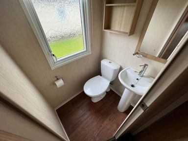 a small bathroom with a toilet and sink at Hafan y Mor Haven - Holiday Accommodation 17436 in Pwllheli
