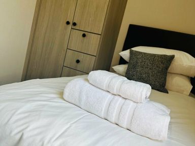 a bed with white towels neatly placed on top at Ashbourne Heights Holiday Park - Holiday Accommodation 18103, Ashbourne