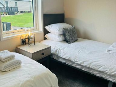 a bedroom with two single beds and a bedside table at Ashbourne Heights Holiday Park - Holiday Accommodation 18103 in Ashbourne