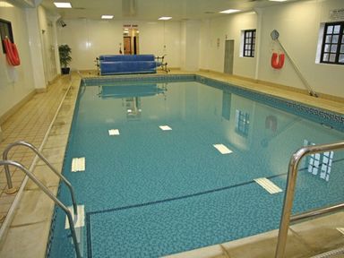 an indoor swimming pool with clear water and poolside steps at Ashbourne Heights Holiday Park - Holiday Accommodation 18103, Ashbourne