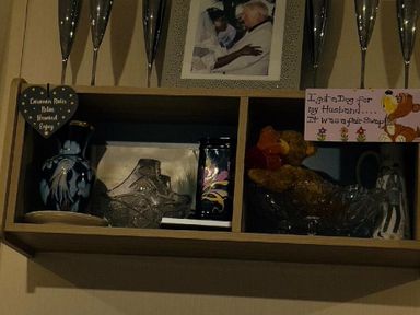 a shelf with decorative items including vases, a photo, and a note at Breydon Water Holiday Park - Holiday Accommodation 18490, Great Yarmouth