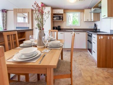 a dining area with a table set for meals at Kelling Heath Holiday Park - Holiday Accommodation 18663 in Holt