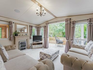 a living room with seating and a television at Kelling Heath Holiday Park - Holiday Accommodation 18664, Holt