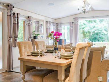 a dining area with a table set for four at Kelling Heath Holiday Park - Holiday Accommodation 18664, Holt