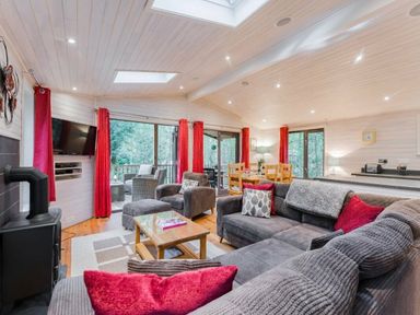 a living room with sofas, a television, and dining table at Kelling Heath Holiday Park - Holiday Accommodation 18691, Holt