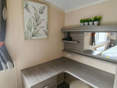A bedroom with a desk and mirror at Whitehouse Leisure Park - Holiday Accommodation 19057, Towyn, Abergele