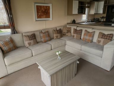 A living room with a sofa and coffee table at Whitehouse Leisure Park - Holiday Accommodation 19057, Towyn, Abergele