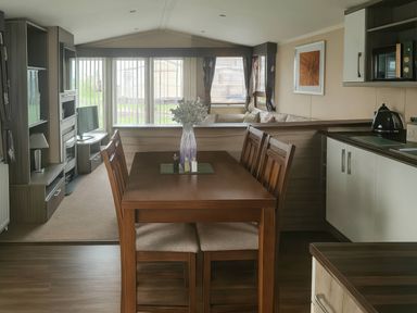 A dining area with a table and chairs at Whitehouse Leisure Park - Holiday Accommodation 19057, Towyn, Abergele