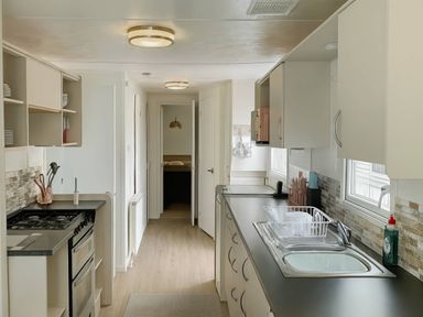 A kitchen with sink and oven at Golden Gate Holiday Centre - Holiday Accommodation 19058 Towyn
