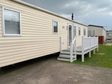 A caravan with steps and windows at Golden Gate Holiday Centre - Holiday Accommodation 19058, Towyn