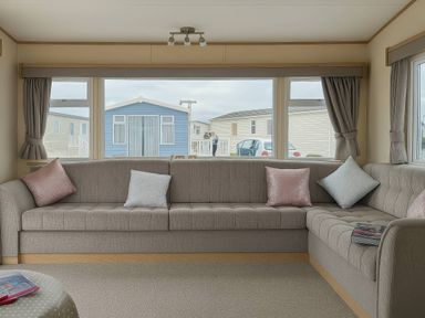 A living room with a sofa and windows at Golden Gate Holiday Centre - Holiday Accommodation 19059 in Towyn