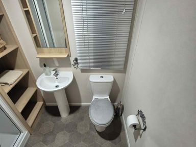A bathroom with a sink and toilet at Presthaven Beach Resort - Holiday Accommodation 19166, Prestatyn
