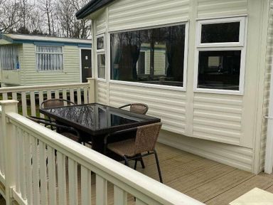 a deck area with a table and chairs at Butlins Skegness - Holiday Accommodation 19332 in Skegness