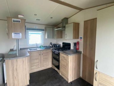 a kitchen with cabinets, appliances, and a window at Butlins Skegness - Holiday Accommodation 19332 Skegness