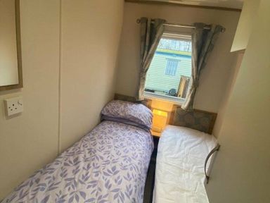 a bedroom with two single beds and a window at Butlins Skegness - Holiday Accommodation 19332, Skegness