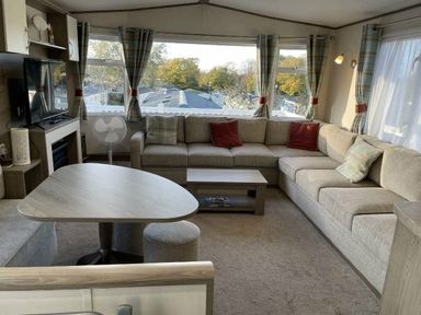 a living room with a sectional sofa and a coffee table at Rockley Park - Holiday Accommodation 19386, Poole,
