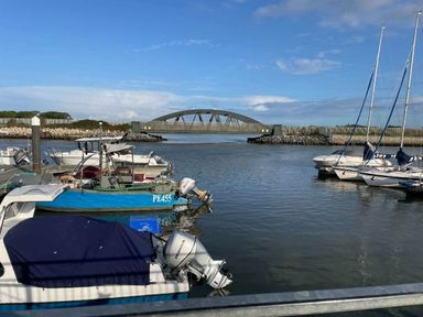 a marina with boats and a bridge over water at Rockley Park - Holiday Accommodation 19386, Poole