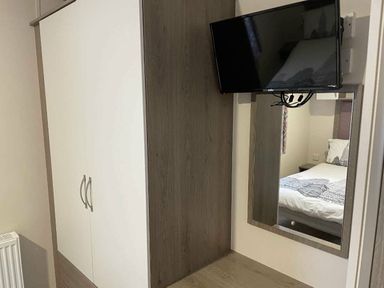 a wardrobe with a television mounted above at Rockley Park - Holiday Accommodation 19386, Poole