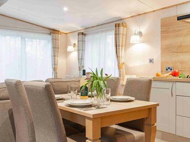 a dining area with a table and chairs at Kelling Heath Holiday Park - Holiday Accommodation 19669 in Holt