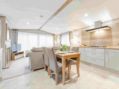 a living room and dining area with a kitchen at Kelling Heath Holiday Park - Holiday Accommodation 19669 in Holt
