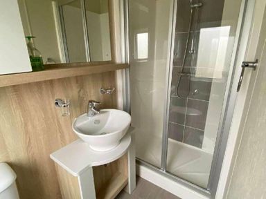 a bathroom with a shower and sink at Pinewoods Holiday Park - Holiday Accommodation 19734 in Wells-Next-The-Sea