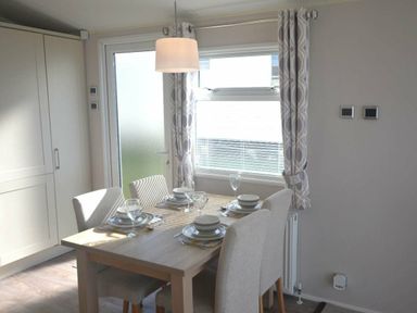 a dining area with a table set for four at Perran Sands - Holiday Accommodation 19778 Perranporth
