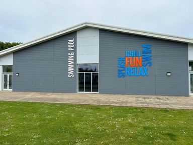 a swimming pool exterior with colorful text at Sand Le Mere Holiday Village - Holiday Accommodation 20326, Tunstall