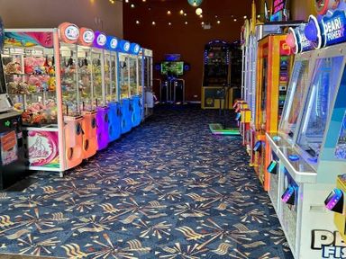 an arcade area with claw machines and game machines at Sand Le Mere Holiday Village - Holiday Accommodation 20326 in Tunstall
