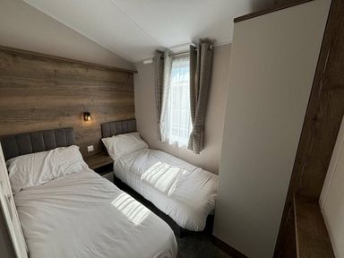 a bedroom with two beds and a window at Hafan y Mor Haven - Holiday Accommodation 20481 in Pwllheli