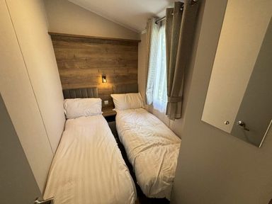 a bedroom with two single beds and a window at Hafan y Mor Haven - Holiday Accommodation 20481 Pwllheli