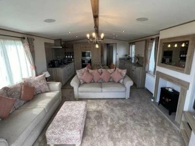 a living room with beige sofas and a coffee table at Lakeland Leisure Park - Holiday Accommodation 20788, Flookburgh