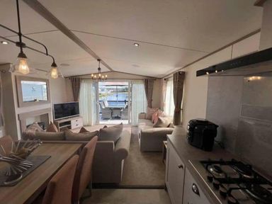 a kitchen area with a view of a seating area and outdoor space at Lakeland Leisure Park - Holiday Accommodation 20788, Flookburgh