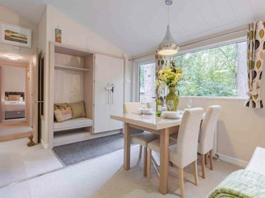 a dining area with a table and chairs overlooking a window at Kelling Heath Holiday Park - Holiday Accommodation 20952, Weybourne