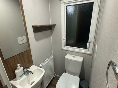 a bathroom with a sink, toilet, and window at Butlins Skegness - Holiday Accommodation 21028 in Skegness