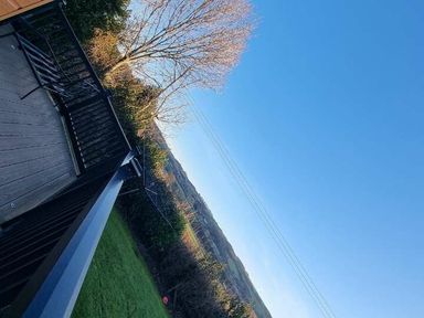 a view from a balcony showing a clear blue sky and distant hills at Presthaven Beach Resort - Holiday Accommodation 21358 in Prestatyn