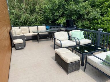 a deck area with seating and a grill at Presthaven Beach Resort - Holiday Accommodation 21358, Prestatyn