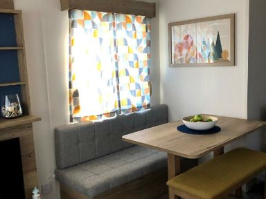 a dining area with a table and bench seating at Greenacres Holiday Park - Holiday Accommodation 21467, Morfa Bychan