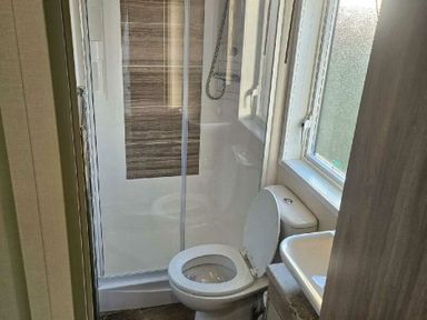 a bathroom with a shower, toilet, and sink at Tattershall Lakes Country Park - Holiday Accommodation 21501, Tattershall