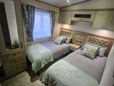 a bedroom with two single beds and a window at Tattershall Lakes Country Park - Holiday Accommodation 21501, Tattershall