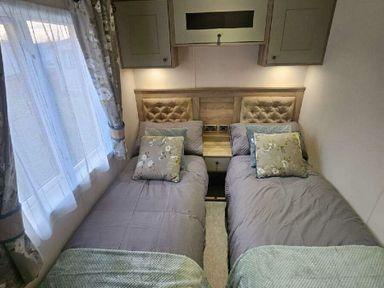 two single beds with decorative pillows in a bedroom at Tattershall Lakes Country Park - Holiday Accommodation 21501, Tattershall