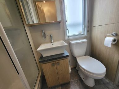a bathroom featuring a toilet, sink, and shower at Swanage Bay View - Holiday Accommodation 21567 in Swanage