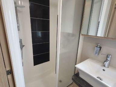 a bathroom with a shower and sink at Swanage Bay View - Holiday Accommodation 21567 in Swanage