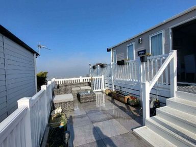a patio area with outdoor furniture and a view at Swanage Bay View - Holiday Accommodation 21567 in Swanage