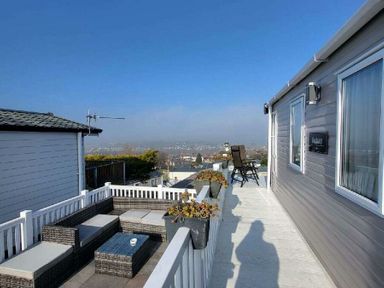 a terrace with seating and a view of the landscape at Swanage Bay View - Holiday Accommodation 21567 in Swanage