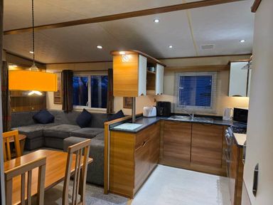 a kitchen and dining area with a table and chairs at Beacon Fell View Holiday Park - Holiday Accommodation 21653, Preston