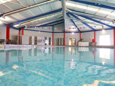 an indoor swimming pool with seating and lockers at Beacon Fell View Holiday Park - Holiday Accommodation 21653 Preston