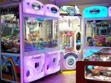 a colorful arcade area with claw machines and prize games at Beacon Fell View Holiday Park - Holiday Accommodation 21653, Preston
