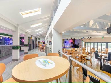 an interior space with tables and chairs in a dining area at Beacon Fell View Holiday Park - Holiday Accommodation 21653 Preston