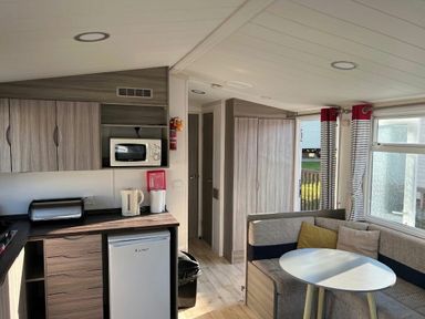 a kitchenette with a refrigerator and microwave in a holiday accommodation at Clarach Bay Holiday Village - Holiday Accommodation 21674 Aberystwyth
